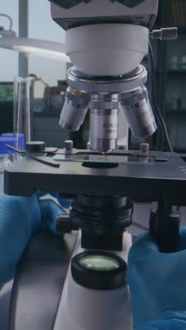 scientist working with a microscope in a laboratory