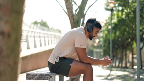 man, bench and phone for music with headphones