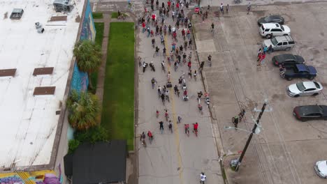 4k-Birds-eye-view-of-bicyclists-riding-through-streets