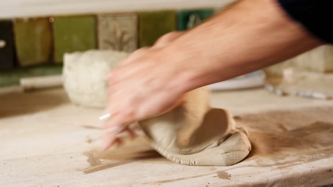 Male potter molding clay