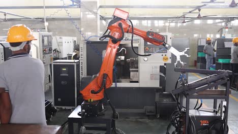 robotic arm picking a raw material of valve part. Industry 5.0, industrial 4.0 concept
