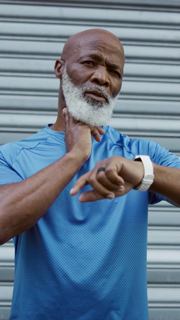 Senior Man Checking Pulse and Smartwatch After Workout