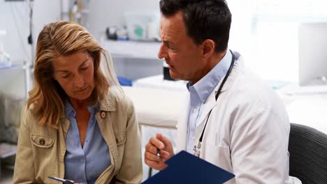 doctor and senior woman discussing over a report