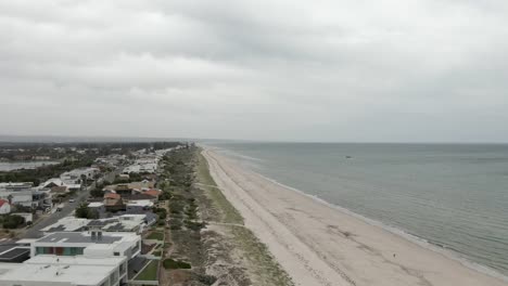 aerial view of residential houses by the beach in adelaide, australia - drone shot