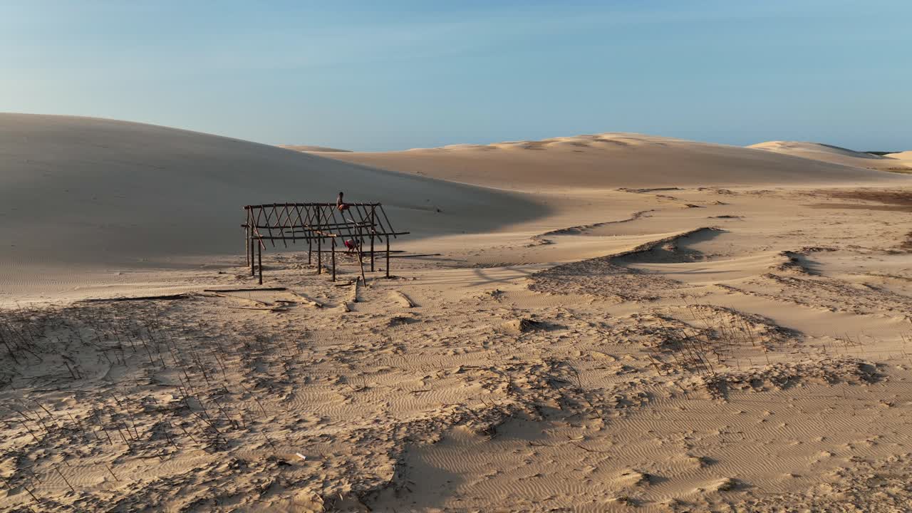 Golden sand dunes with a metal structure in Araioses, Parnaiba River region