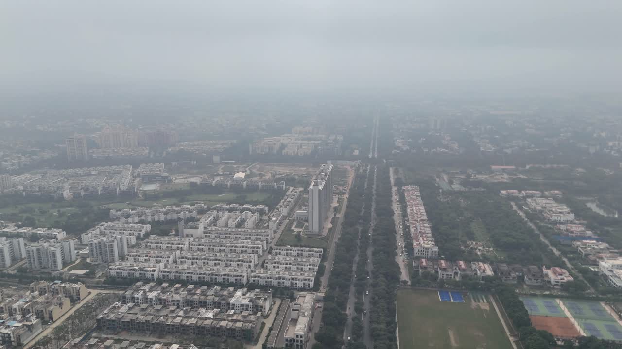 The drone viewpoint captures Greater Noida’s organized neighborhoods and lush green road dividers