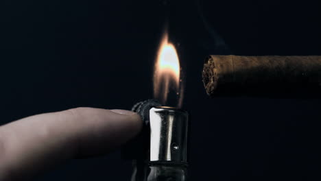 hand lighting a cigar