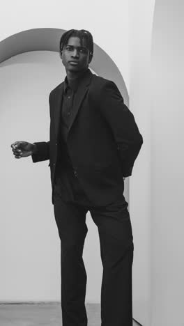 black and white fashion editorial featuring a male model in various sophisticated outfits