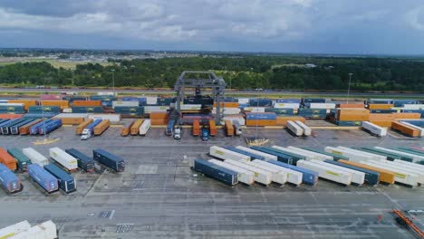 4k drone video of trains and trucks at csx intermodal train yard in winter haven, fl