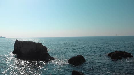 Close-to-water-drone-shot-between-cliffs-and-rocks-near-seashore-2