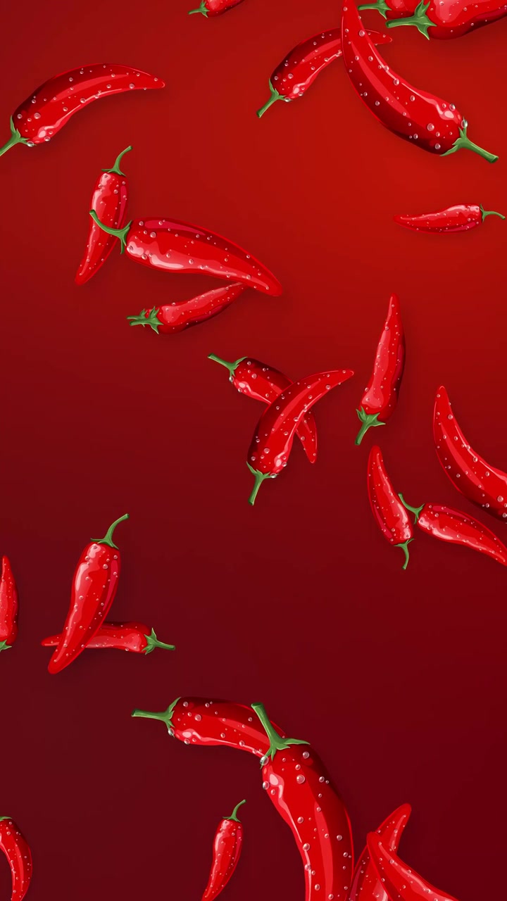 Fresh red chili peppers fall and tumble through a vertical frame on red background.