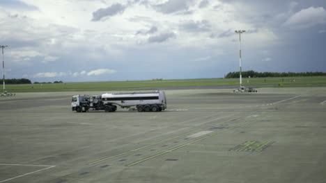 an aviation fuel truck on an airport driving on the runway