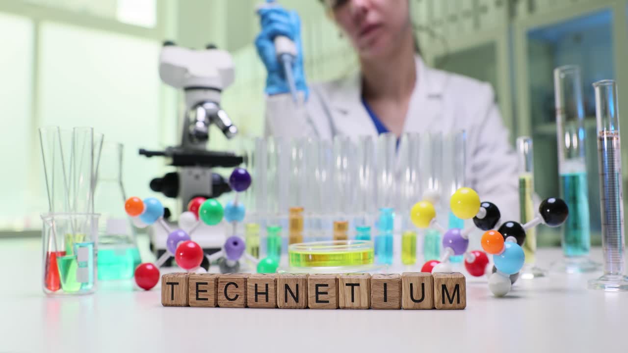 Scientist Working in a Laboratory with Technetium Blocks and Lab Equipment