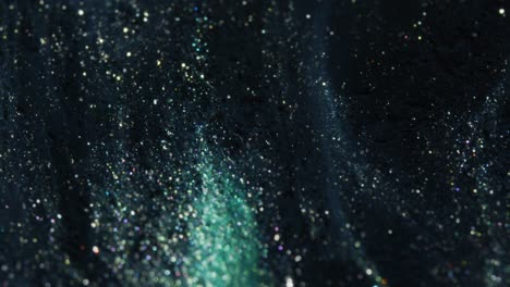 multicolored crystals sparkle on blue background. fluid art.