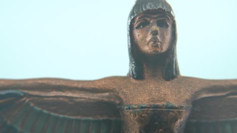 dreamy macro shot of a cleopatra statue with wide open wings, hazy depth of field, ancient egypt queen of kings, egyptian historical ruler, antique artwork of a goddess, smooth 4k video pan right