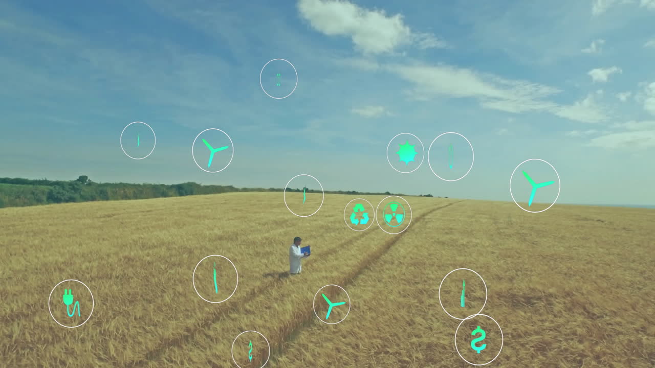 Agronomist researcher working on laptop in wheat field, showing floating energy icons