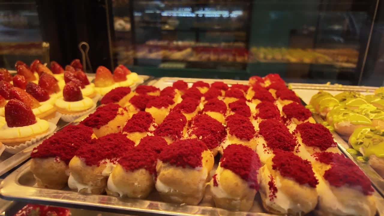 Display of Strawberry Tarts and Red Velvet Eclairs