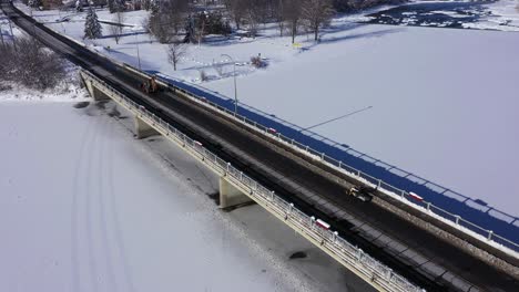 snowmobile-is-forced-to-drive-on-road-to-cross-bridge-aerial