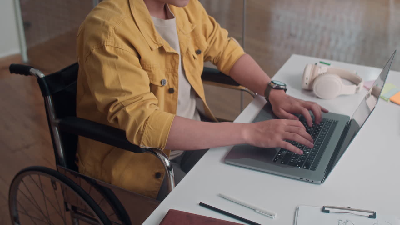 Developer in Wheelchair Working on Wireless Laptop
