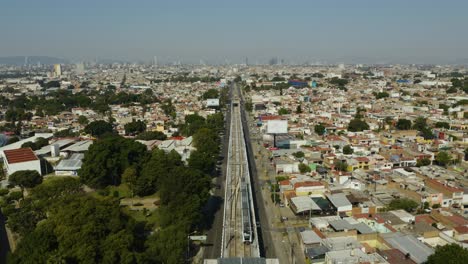 Train-Enters-Frame-Moving-Towards-Downtown-Guadalajara,-Mexico