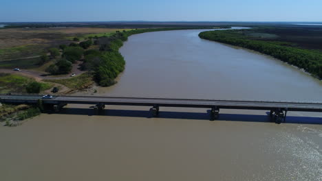 Aerial-of-car-driving-over-bridge