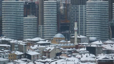 snowy cityscape with modern and traditional architecture