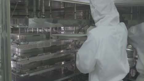 a pristine storage of vaccine vials are stored in lab refrigerators inside sterile production facility to ensure safety and quality during manufacturing process for medical research and diagnostics