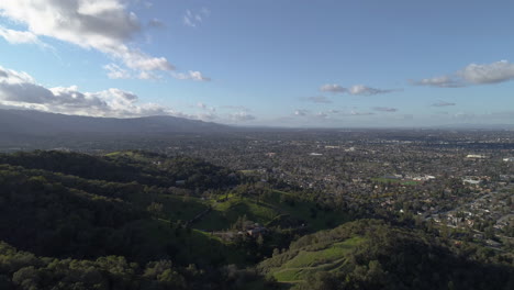 Flying-over-green-mountains-and-trees-in-San-Jose,-CA