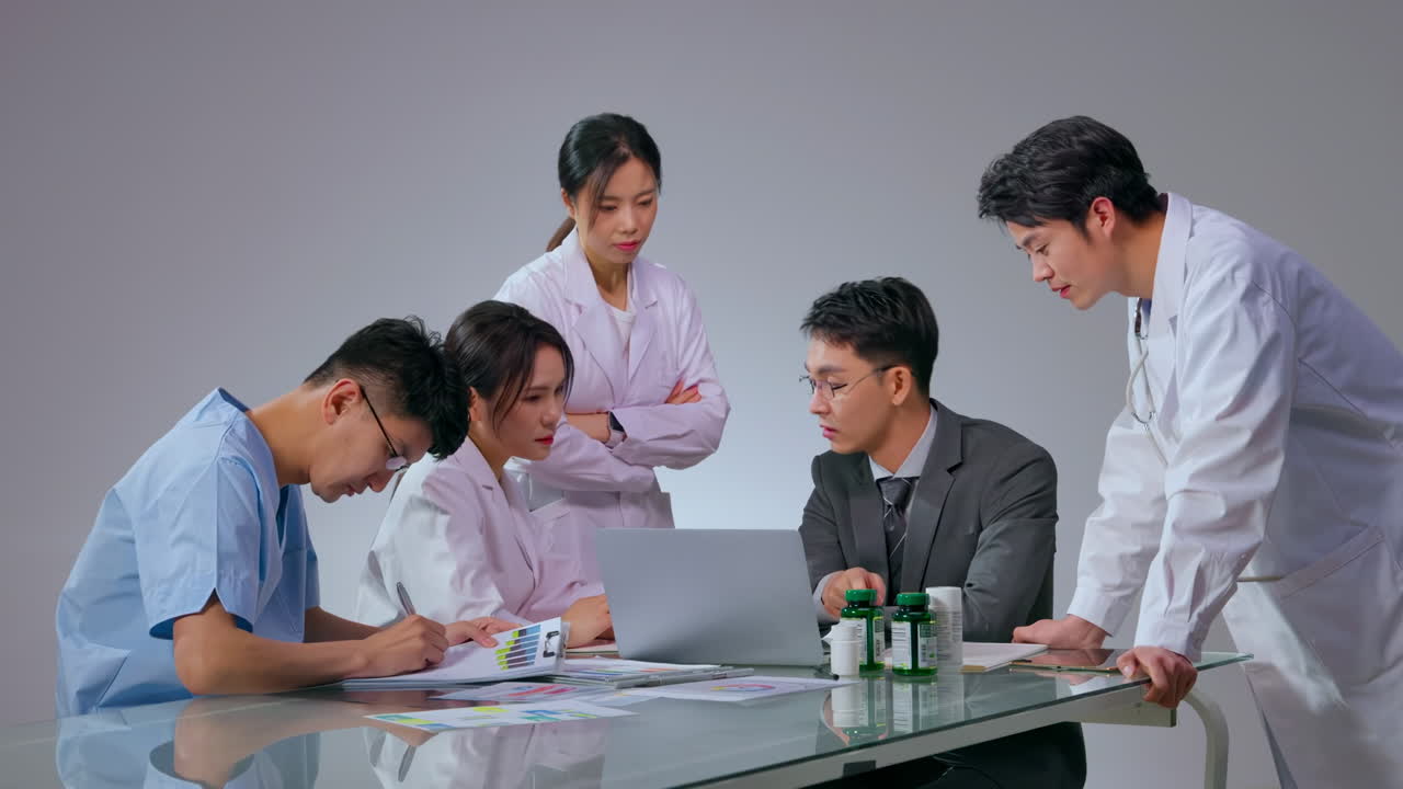 Male pharmaceutical representative business agent medical team and showing prescription medication to doctor in hospital