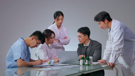 male pharmaceutical representative business agent medical team and showing prescription medication to doctor in hospital
