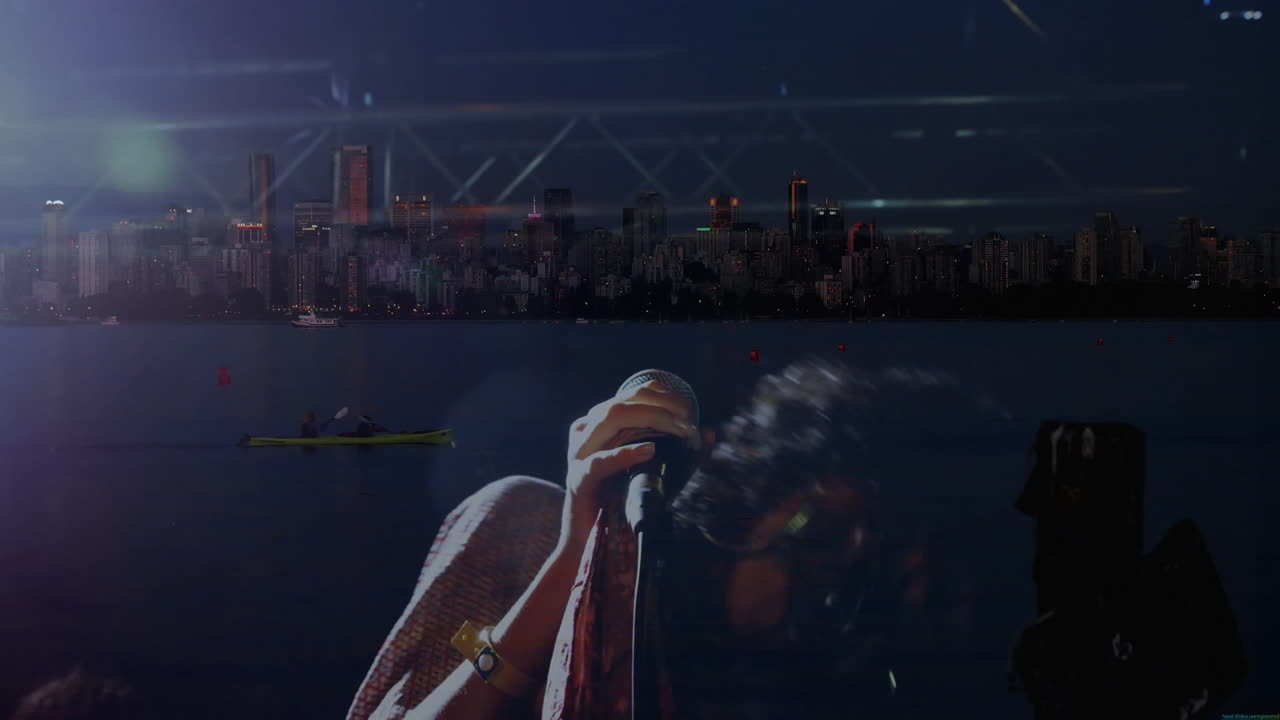 Female singer performing music on mic on waterfront stage, with lens flares and skyline reflection