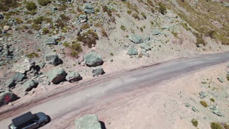 Car-With-Folded-Rooftop-Tent-Driving-On-Mountain-Road-Near-Santiago-In-Chile