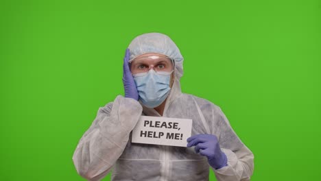 man in hazmat suit holding sign asking for help