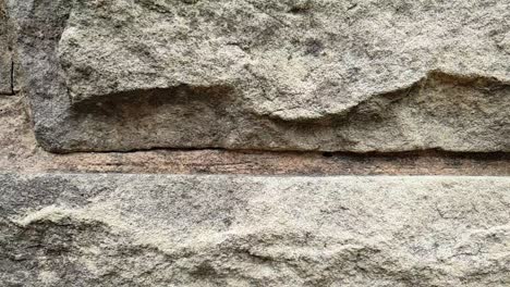 brown sandstone bricks slow motion slide on side of barbecue fireplace chimney, natural stone texture and patterns