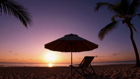 stunning tropical beach sunset with umbrella and chair