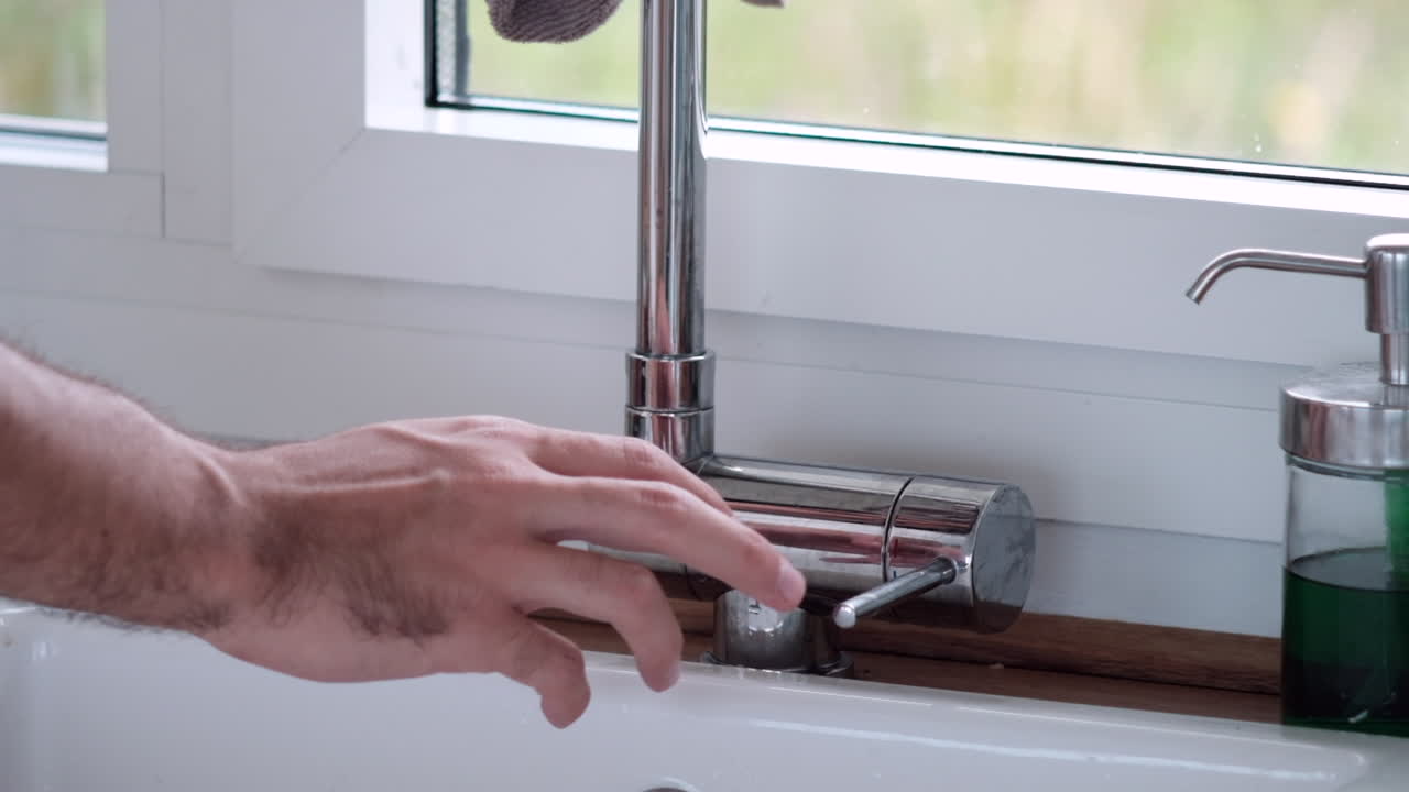 Man's Hand Turning Off Water Tap, Eco-Friendly