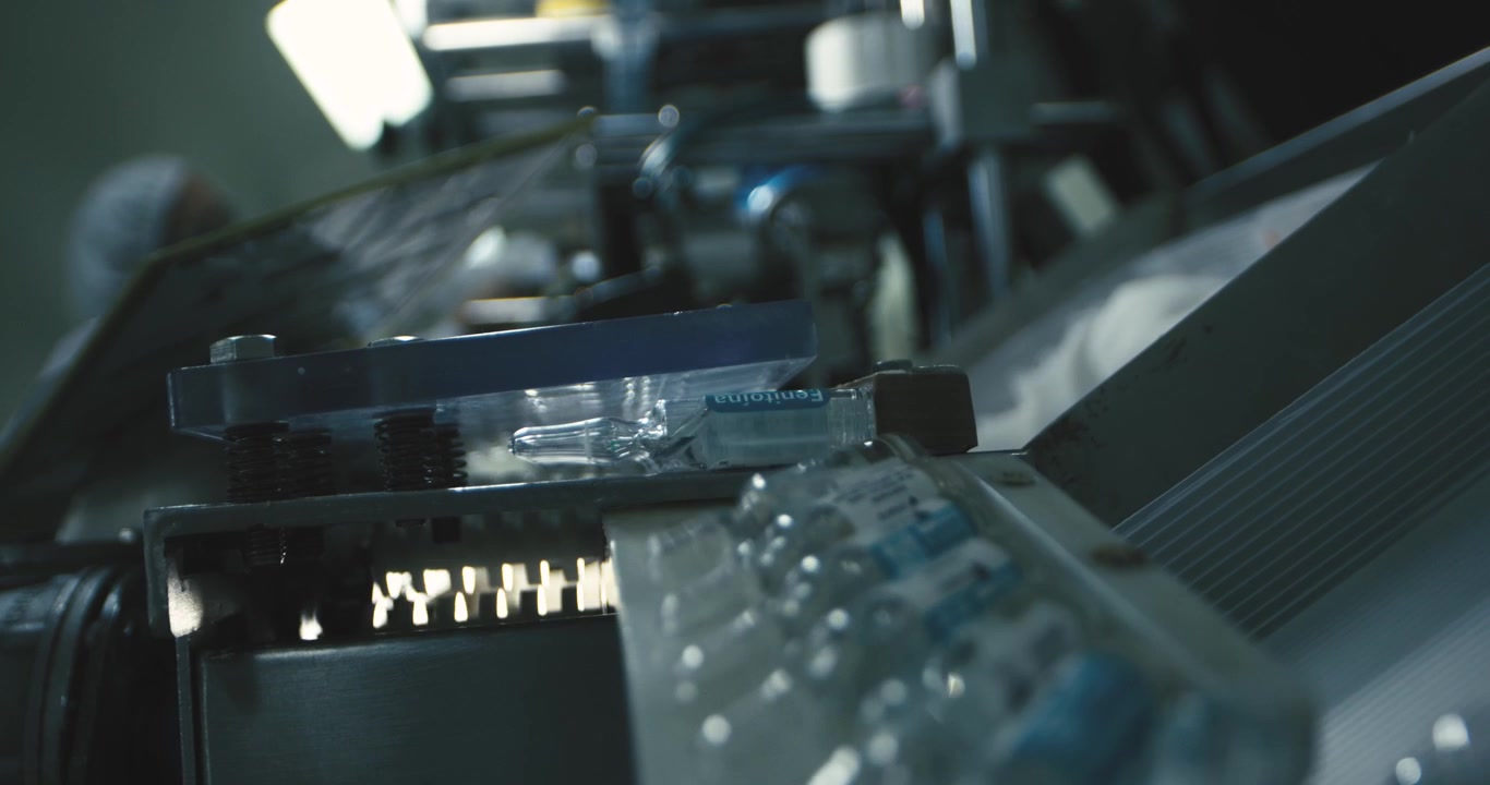 Industrial assembly line packaging vaccine vials with precision in a factory under sterile, well-lit conditions