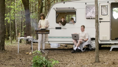 happy nomad family spending time together at the camping in the forest