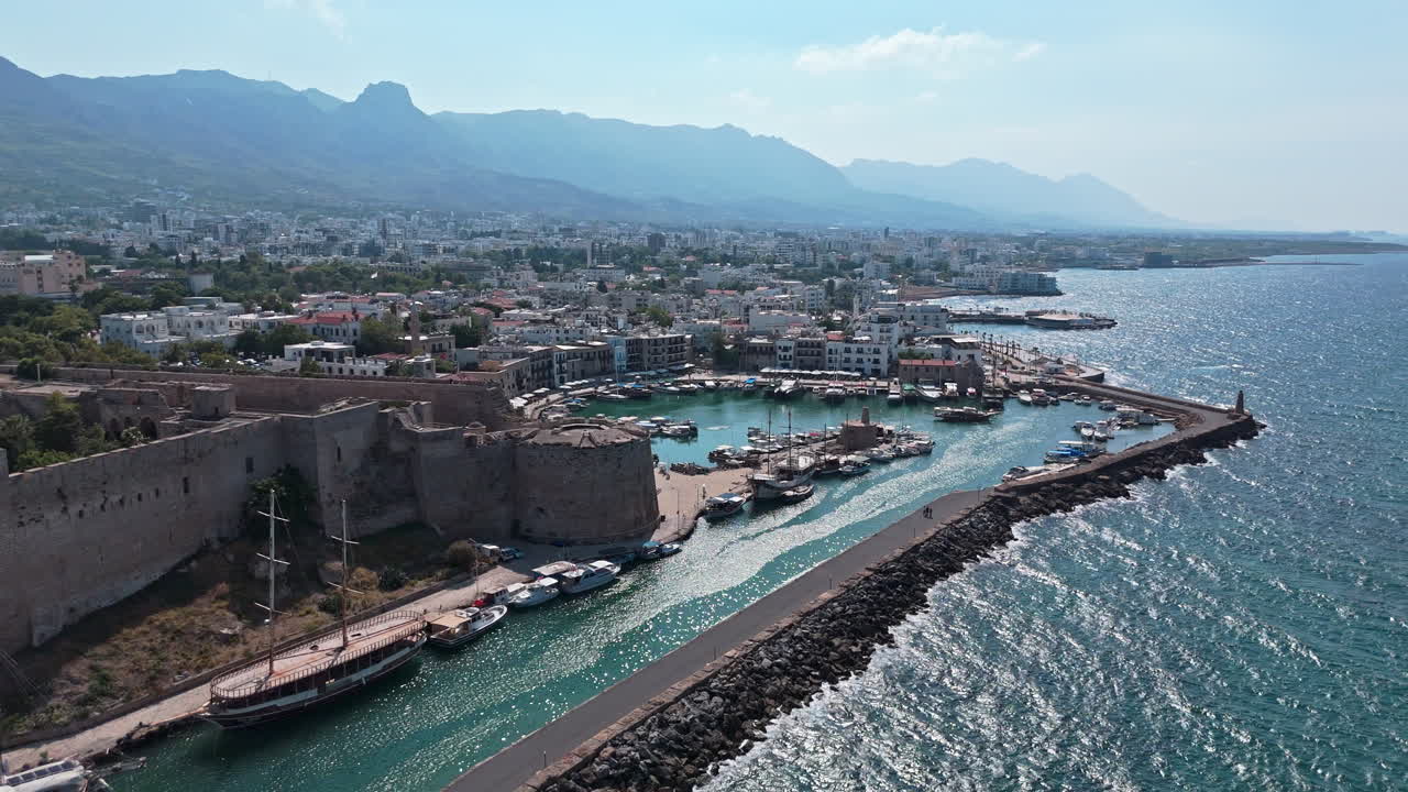 Kyrenia harbor with historic castle and mountains along the mediterranean coast , aerial view