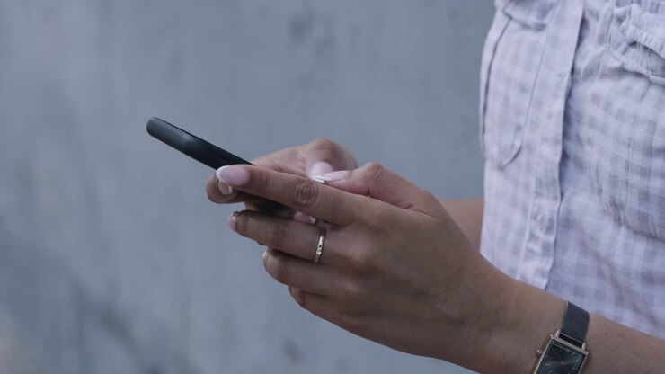 Closeup of hands texting on a phone
