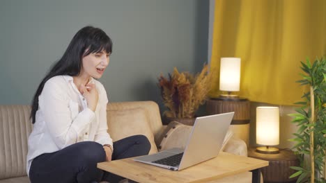 woman watching movie on laptop at night.