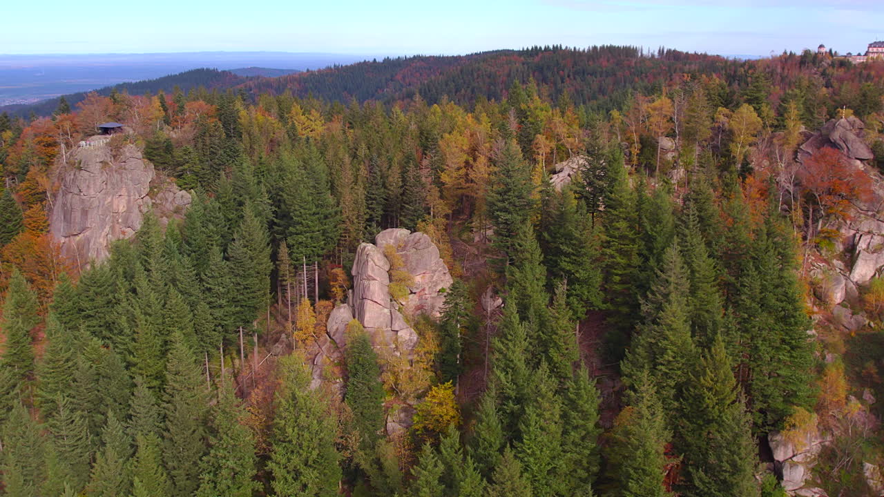 Aerial view of the rocks Brockenfelsen, Falkenfelsen and the shelter hut Herta Hütte in the Black Forest region Bühlertal on a colorful autumn day. Chateau Hotel Bühlerhöhe in the background