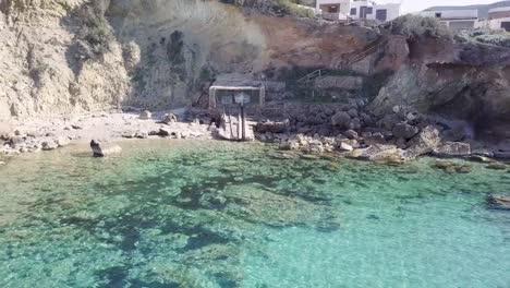 Aerial-shot-of-boat-storage-next-to-sea-with-tropical-turquoise-water