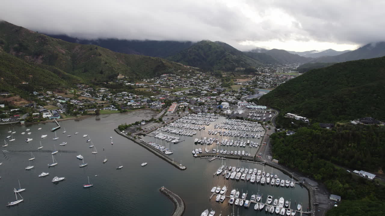 Establishing drone shot toward the Waikawa marina and townscape, in cloudy NZ