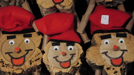 cute wooden log figurines with red hats