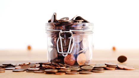 close-up of coins falling in bottle