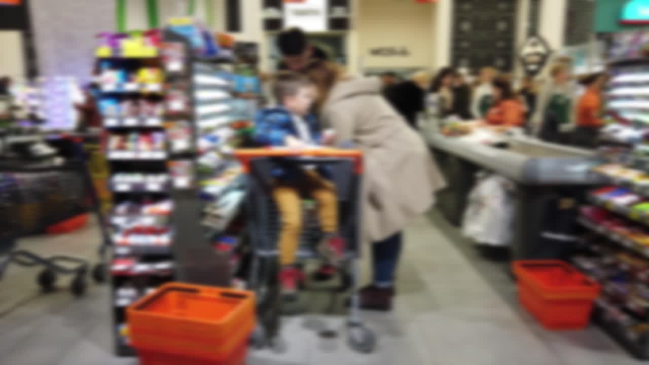 People pay for cash purchases. Shooting in mall. Out of focus
