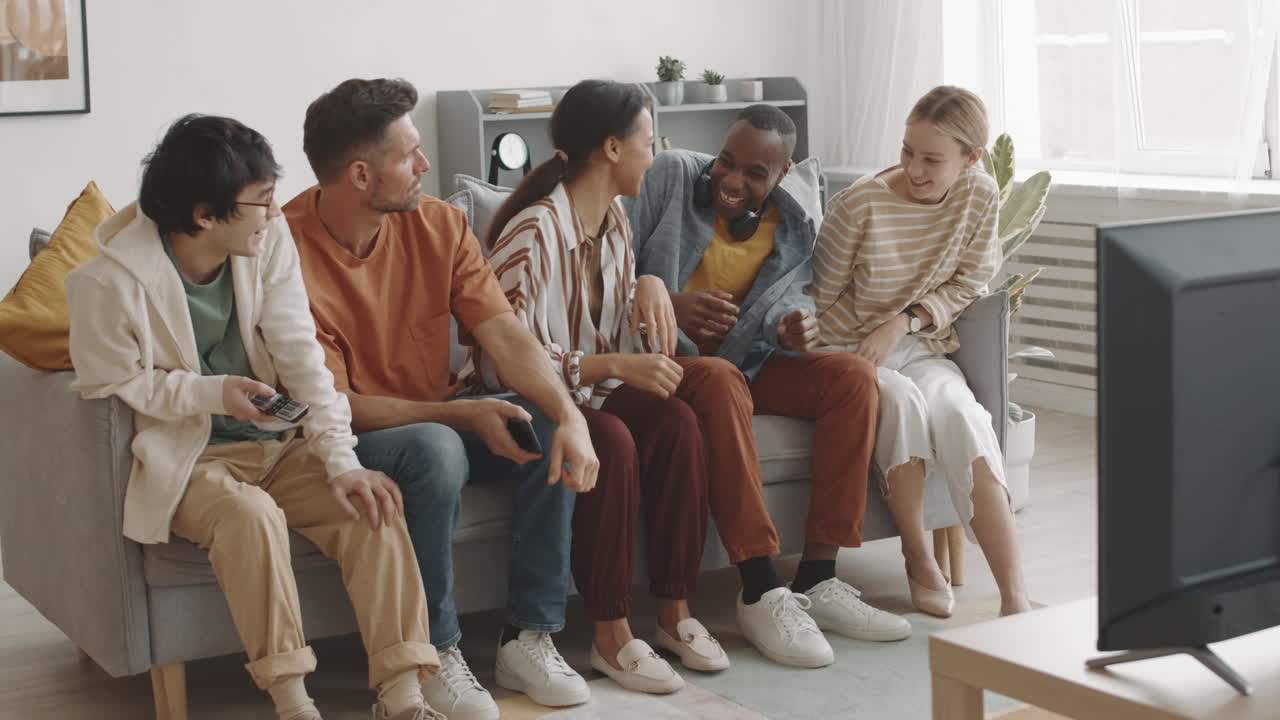 Man Scaring Woman Watching TV