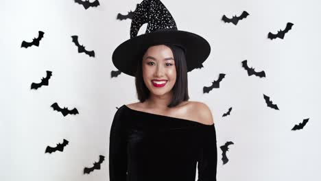 smiling woman in a witch costume