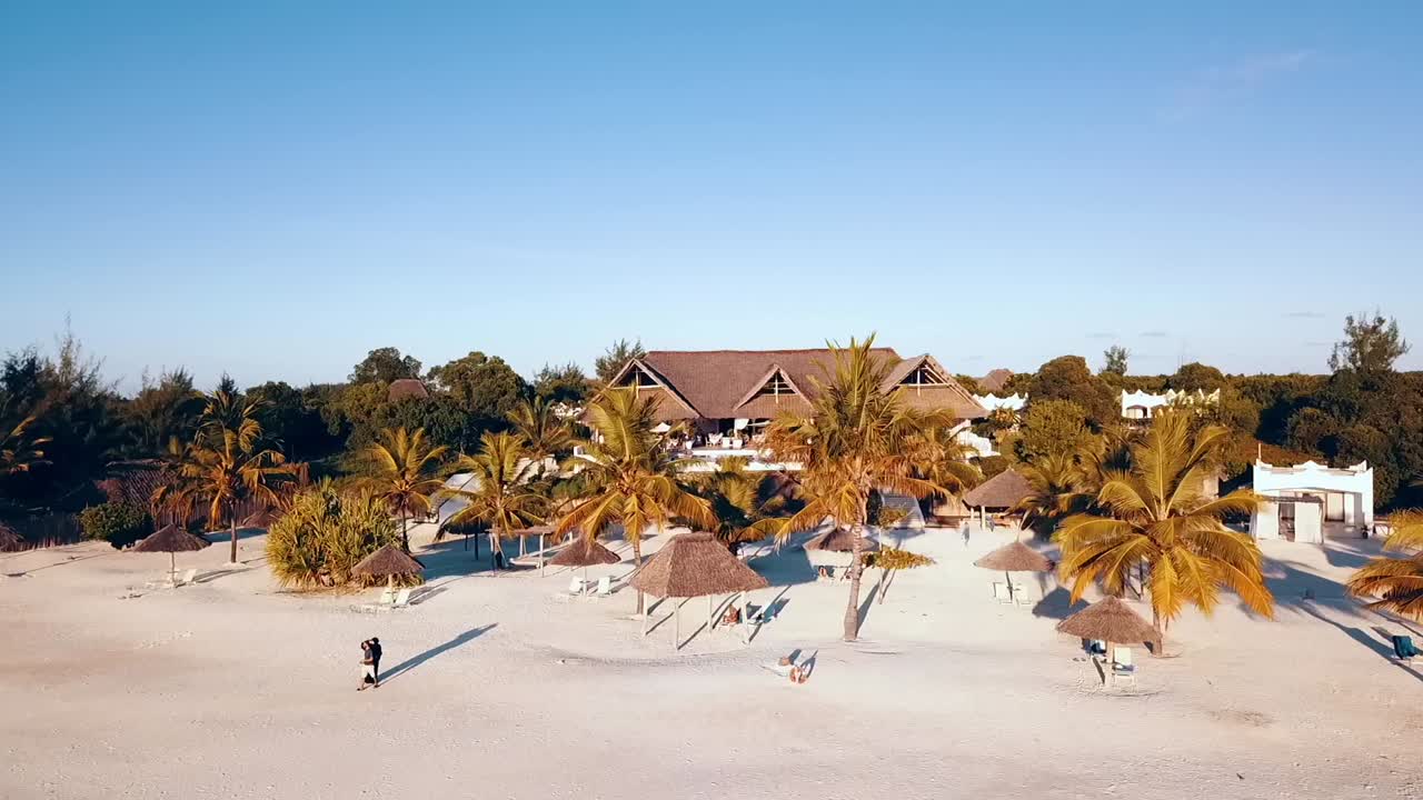 Unbelievable backwards slowly rise up drone shot at sunset long shadows from a luxury villa to sea
Drone shot on Zanzibar at Africa in winter 2019